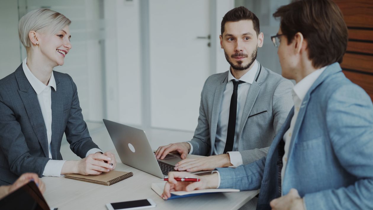 Business professionals discussing strategy in a modern office meeting