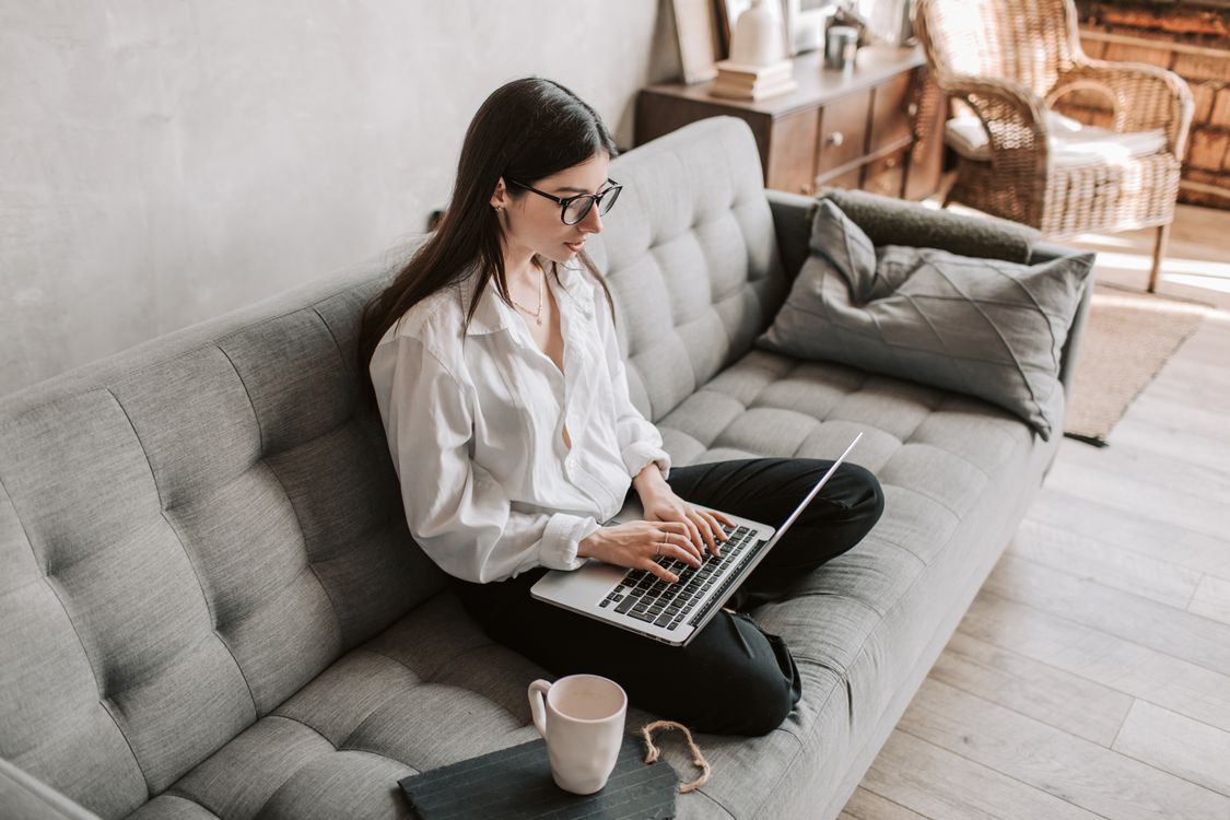 Person working remotely on a laptop from home, representing a remote IT job