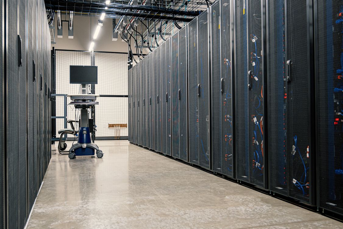 Data center corridor with server racks representing infrastructure and cloud career growth