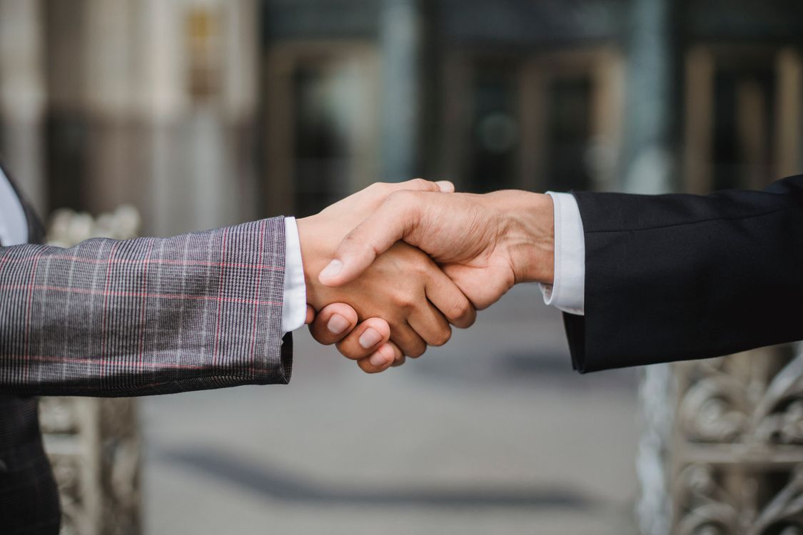 Two businesspeople shaking hands, symbolizing agreement after a job interview