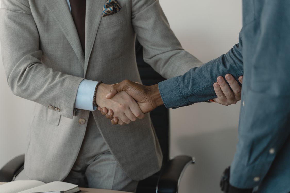 Close-up of a professional handshake symbolizing a successful interview outcome