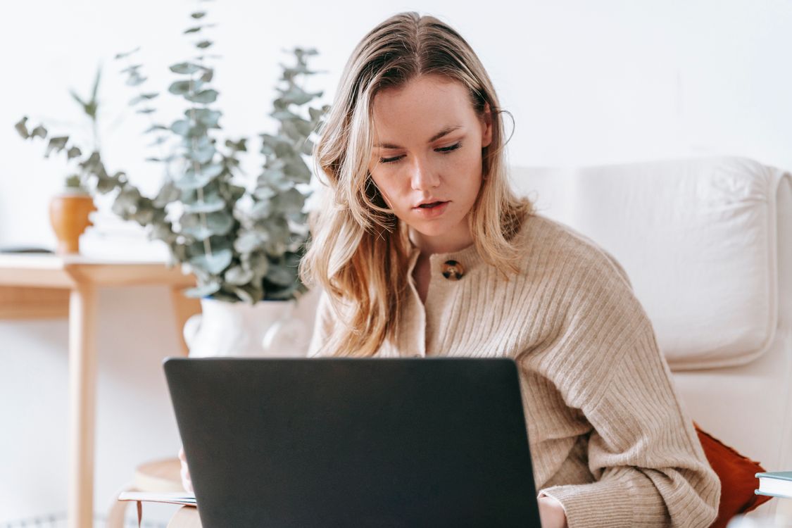 Freelancer working on a laptop at home managing a client project