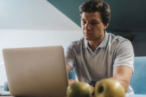 Freelancer focused on working on a laptop in a home setting
